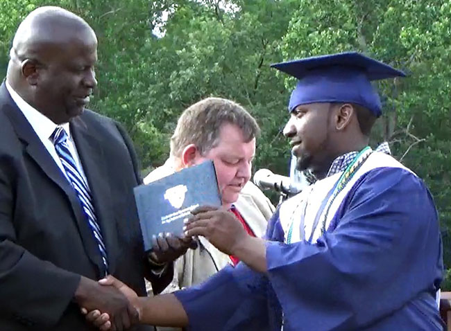 Jaquez Perry receives his diploma from the principal.